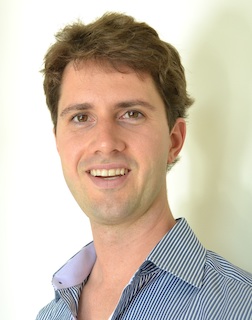 the professionally taken portrait of Todd, with brown hair and brown eyes, wearing a blue dress shirt with soft purple collar